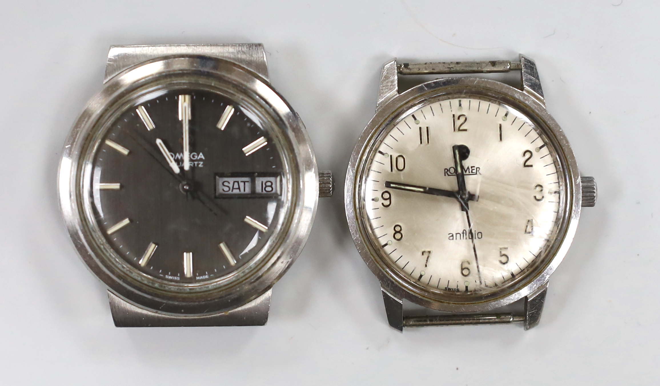 A gentleman's stainless steel Omega quartz day date wrist watch, case diameter 38mm, no strap, together with a gentleman's stainless steel Roamer manual wind wrist watch.